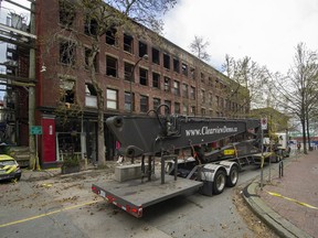 A crane arrives for demolition of the Winters Hotel, destroyed last week by fire.