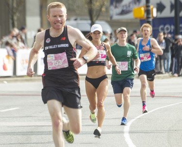 #253 Frank Woolstencroft and third-place women's winner Lanni Marchant during Vancouver Sun Run on April 24, 2022.