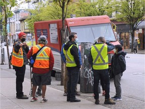 Canada Post delivery workers meet at E. Hastings St as workers complain of unsafe conditions and refuse to deliver mail in the Downtown Eastside. Nick Procello photo.