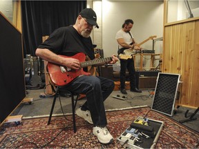 Canadian rock legend Jerry Doucette (left) tunes his guitar prior to recording in this archive image from 2013. Doucette passed away on April 18 following a battle with cancer.