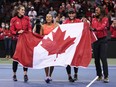Canada's Rebecca Marino, from left to right, Leylah Annie Fernandez, captain Heidi El Tabakh and Francoise Abanda celebrate after Fernandez defeated Latvia's Daniela Vismane during a Billie Jean King Cup qualifier singles tennis match, in Vancouver, on Saturday.