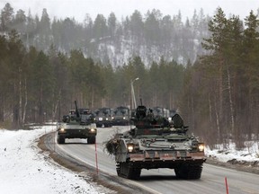 Swedish Army armoured vehicles and tanks participate in a military exercise called "Cold Response 2022", gathering around 30,000 troops from NATO member countries as well as Finland and Sweden, amid Russia's invasion of Ukraine, in Setermoen in the Arctic Circle, Norway, March 25, 2022.