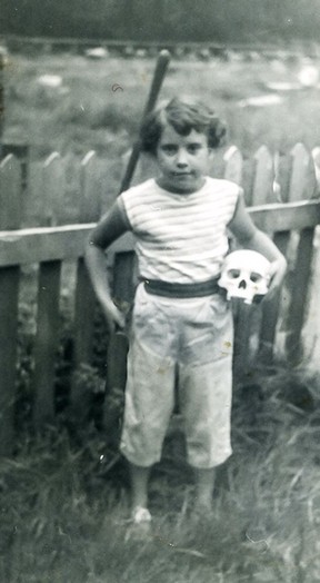 Child writer Kathryn Willcock holding a human skull in the wilderness of coastal British Columbia