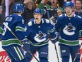 Alex Chiasson #39 of the Vancouver Canucks celebrates with teammates J.T. Miller #9 and Vasily Podkolzin #92 after scoring a goal against the Phoenix Coyotes during the first period at Rogers Arena on April 14, 2022 in Vancouver.
