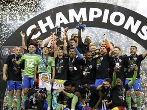The Seattle Sounders celebrate after beating Pumas 3-0 during 2022 Scotiabank Concacaf Champions League Final Leg 2 at Lumen Field on May 04, 2022 in Seattle, Washington.