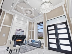 This Richmond residence boasts an impressive foyer with soaring ceilings and a crystal chandelier with detailed ceiling rose overhead.