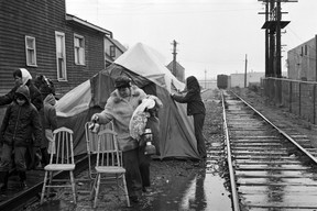 Single mothers living at the Raymur Place Social Housing Project (now Stamps Place) in the Downtown Eastside remove their protest camp blocking train tracks to the Port of Vancouver after the CPR agrees to safety measures for local children. A pedestrian overpass to Admiral Seymour school was eventually built. March 26, 1971. Glenn Baglo/Vancouver Sun