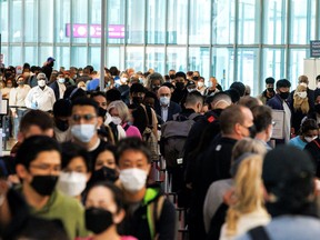 Travellers crowd the security queue in the departures lounge at the start of the Victoria Day holiday long weekend at Toronto Pearson International Airport in Mississauga, Ontario, Canada, May 20, 2022. REUTERS/Cole Burston