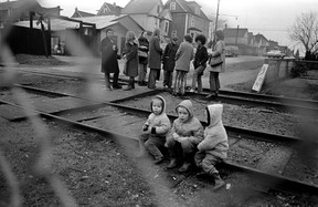 Several members of the Militant Mothers of Raymur stand on top of the railway tracks in the 1000 block East Pender, Jan. 27, 1971. Three of their children are in the front.  Ross Kenward/Vancouver Province