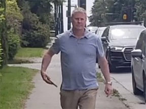 A screen grab of Vancouver realtor Randy Vogel taking down posters of Chelsea Poorman, whose body was found in the Shaughnessy neighbourhood earlier this year.