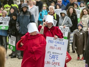 In a file photo, pro-choice advocates walk through an anti-abortion rally in Edmonton.