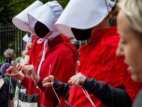 Members of the Boston Red Cloaks gather at the State House to protest the overturning of Roe vs. Wade and call for support of pro choice for all women in the US in Boston, Massachusetts on May 7, 2022.