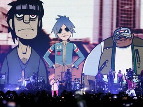 English singer Damon Albarn (C) performs with his band Gorillaz at Movistar Arena in Bogota on May 12, 2022. (Photo by Juan Pablo Pino / AFP)