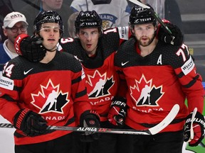 Canada's Cole Sillinger, left, celebrates with Matt Barzal, centre, and Canadiens' Josh Anderson during the IIHF Ice Hockey World Championships semifinal match against Czechia in Tampere, Finland, on Saturday, May 28, 2022.