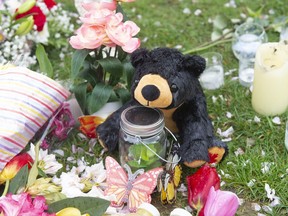 A stuffed animal is part of a memorial for a 14-year-old girl on 11th Avenue near 16th Street in Burnaby on May 10, 2022. The girl was killed when she was struck by a dump truck last week.