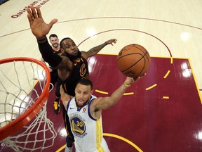 LeBron James attempts to block a Stephen Curry shot in Game 3 of the NBA Finals on June 6. James is the world's highest-paid athlete, according to Sportico, and Curry isn't too far behind.