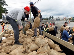 People fill sandbags in Abbotsford during the November floods.  Riverside communities are stepping up flood preparations again as the Fraser River continues to rise.