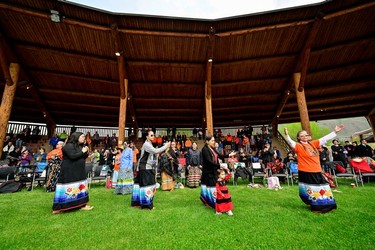 Tk'emlups te Secwepemc community members perform a welcome song during a memorial event marking the first anniversary of the discovery of unmarked Indigenous children's graves at the Tk'emlups Pow Wow Arbour in Kamloops, B.C., May 23, 2022.