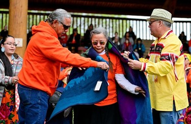 Jackie Jules, a cultural educator at the Secwepemc Museum and Heritage Park, is honoured during a ceremony marking the first anniversary of the discovery of unmarked Indigenous child graves at the Tk'emlups Pow Wow Arbour in Kamloops, B.C., May 23, 2022.