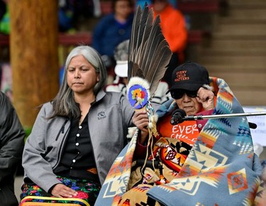 Elder Mona Jules, a residential school survivor, speaks as Nancy Bonneau comforts her during a memorial event to mark the one-year anniversary of the discovery of unmarked Indigenous children's graves at the Tk'emlups Pow Wow Arbour in Kamloops, B.C., May 23, 2022.