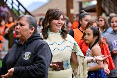 Tk'emlups te Secwepemc Kukpi7 (Chief) Rosanne Casimir dances with community members at a memorial event marking the first anniversary of the discovery of unmarked Indigenous child graves at the Tk'emlups Pow Wow Arbour in Kamloops, B.C., May 23, 2022.