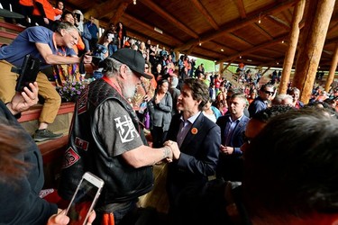 Canada's Prime Minister Justin Trudeau greets Tk'emlups te Secwepemc community members at a memorial event marking the first anniversary of the discovery of unmarked Indigenous child graves at the Tk'emlups Pow Wow Arbour in Kamloops, B.C., May 23, 2022.