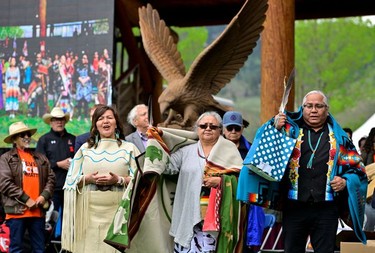 Tk'emlups te Secwepemc community members attend a memorial event marking the first anniversary of the discovery of unmarked Indigenous child graves at the Tk'emlups Pow Wow Arbour in Kamloops, B.C., May 23, 2022.