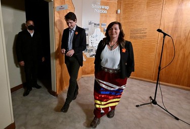 Canada's Prime Minister Justin Trudeau walks with Tk'emlups te Secwepemc Kukpi7 (Chief) Rosanne Casimir after they addressed the media while attending a memorial marking the first anniversary of the announcement of the discovery of unmarked Indigenous child graves at the Tk'emlups Pow Wow Arbour in Kamloops, B.C., May 23, 2022.