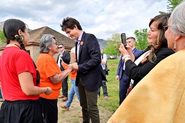Canada's Prime Minister Justin Trudeau greets Tk'emlups te Secwepemc community members at a memorial event marking the first anniversary of the discovery of unmarked Indigenous child graves at the Tk'emlups Pow Wow Arbour in Kamloops, B.C., May 23, 2022.