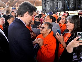 Canada's Prime Minister Justin Trudeau greets Charolette Ned of Quilchena (Sylix Nation) at a memorial event marking the first anniversary of the discovery of unmarked Indigenous child graves at the Tk'emlups Pow Wow Arbour in Kamloops, B.C., May 23, 2022.