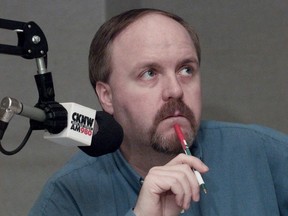 Host Dan Russell ponders a listener’s question at the Sportstalk mic in 2000.