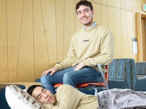 University of British Columbia entrepreneurs Noah Silverman and Yuki Kinoshita (sleeping in bed) are the co-founders of Plufl, a dog bed for humans. Photo credit: Thandi Fletcher, UBC.