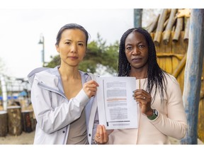 Michele Tung and Stembile Chibebe with a copy of a "special covenant" attached to Tung's property from the land title office in New Westminster, before she could get a building permit. That covenant said that her property could not be owned by anyone of Asian or Black descent.