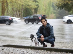 "It seems like someone didn't think this through," says Port Moody's Riti Chrea, shown with his puppy Oreo. A new parking reservation system at Buntzen Lake in Anmore will limit the hiker's ability to do longer trails.