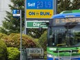 A TransLink bus passes a gas station displaying near-record prices in Surrey on Tuesday, May 17, 2022.