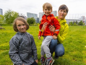Lisa McAllister with her son Niko and daughter Daria in the Vancouver field designated for a school that was never built.
