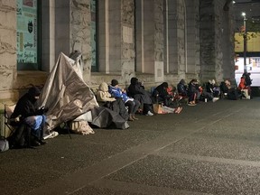 People waiting for a passport office at Sinclair Centre in downtown Vancouver to open Friday morning.