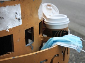 Discarded disposable cups and masks in Vancouver, BC., on May 11, 2022.