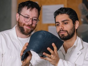 Handout photo of Bioform's Jordan MacKenzie (left) and (right) Rami Younes showing a sheet of the bioplastic.