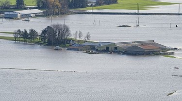 BEFORE: A farm is surrounded by flood waters in Abbotsford, Nov., 17, 2021.