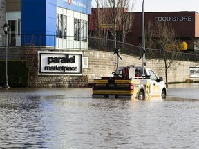 A traffic truck sits in flood waters outside Parallel Marketplace in Abbotsford, BC, November, 17, 2021.
