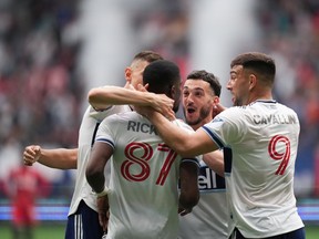 Vancouver Whitecaps' Russell Teibert, back, Tosaint Ricketts (87), Lucas Cavallini (9) and Ranko Veselinovic, back left, celebrate Ricketts' goal against Toronto FC during the second half of an MLS soccer game in Vancouver, B.C., Sunday, May 8, 2022.
