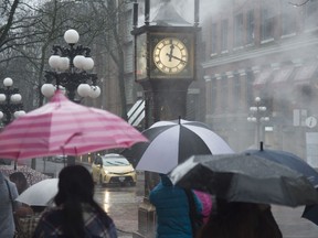People walk by the steam clock in Gas Town in downtown Vancouver, B.C., Tuesday, December, 31, 2019.&ampnbsp;Environment Canada warns prolonged rains will drench parts of northern B.C. over the weekend, raising the potential for localized flooding.&ampnbsp;THE CANADIAN PRESS/Jonathan Hayward