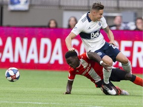 Whitecaps defender Jake Nerwinski gets undercut by Cavalry FC's Nathan Mavila during their 2019 Canadian Championship game at B.C. Place, a loss that bounced the Caps out of the competition.