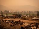 Thick smoke fills the air and nearly blocks out the sun as a property destroyed by the White Rock Lake wildfire is seen in Monte Lake, east of Kamloops, BC, on Saturday, August 14, 2021.
