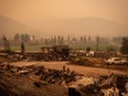 Thick smoke fills the air and nearly blocks out the sun as a property destroyed by the White Rock Lake wildfire is seen in Monte Lake, east of Kamloops, B.C., on Saturday, August 14, 2021.