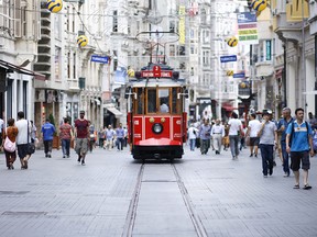 Trams run up and down lively Istiklal Street.