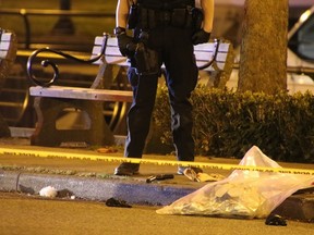 A handgun with a silencer lies on the ground between a Vancouver police officer's feet following the 2021 murder of Harpreet Dhaliwal in Coal Harbour.