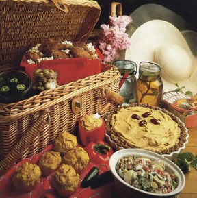 In a southern-style picnic basket are popcorn-packed Cajun drumsticks, jalapeño potato salad, and jars of Cajun martinis and iced tea.