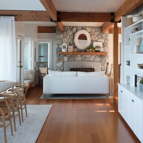 The Parker & Harlow team elevated an original stonework fireplace with coastal-themed decor objects, adding new seating for evening games and guitar strumming.